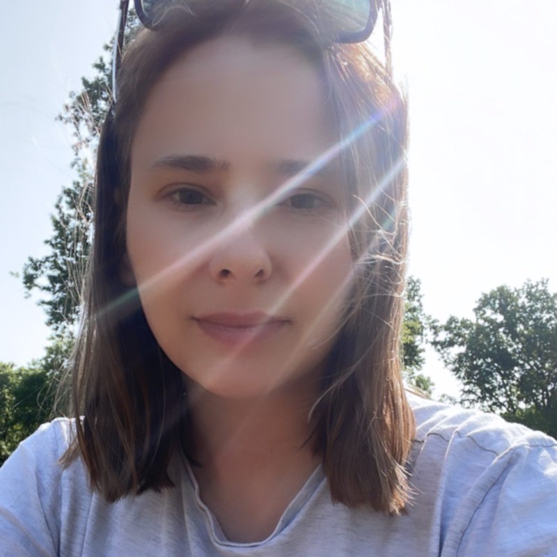 Anna, creator of The Reading Room, outdoors in the sunshine
